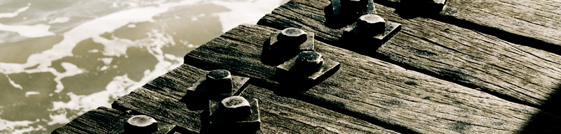 Weathered wooden jetty over water